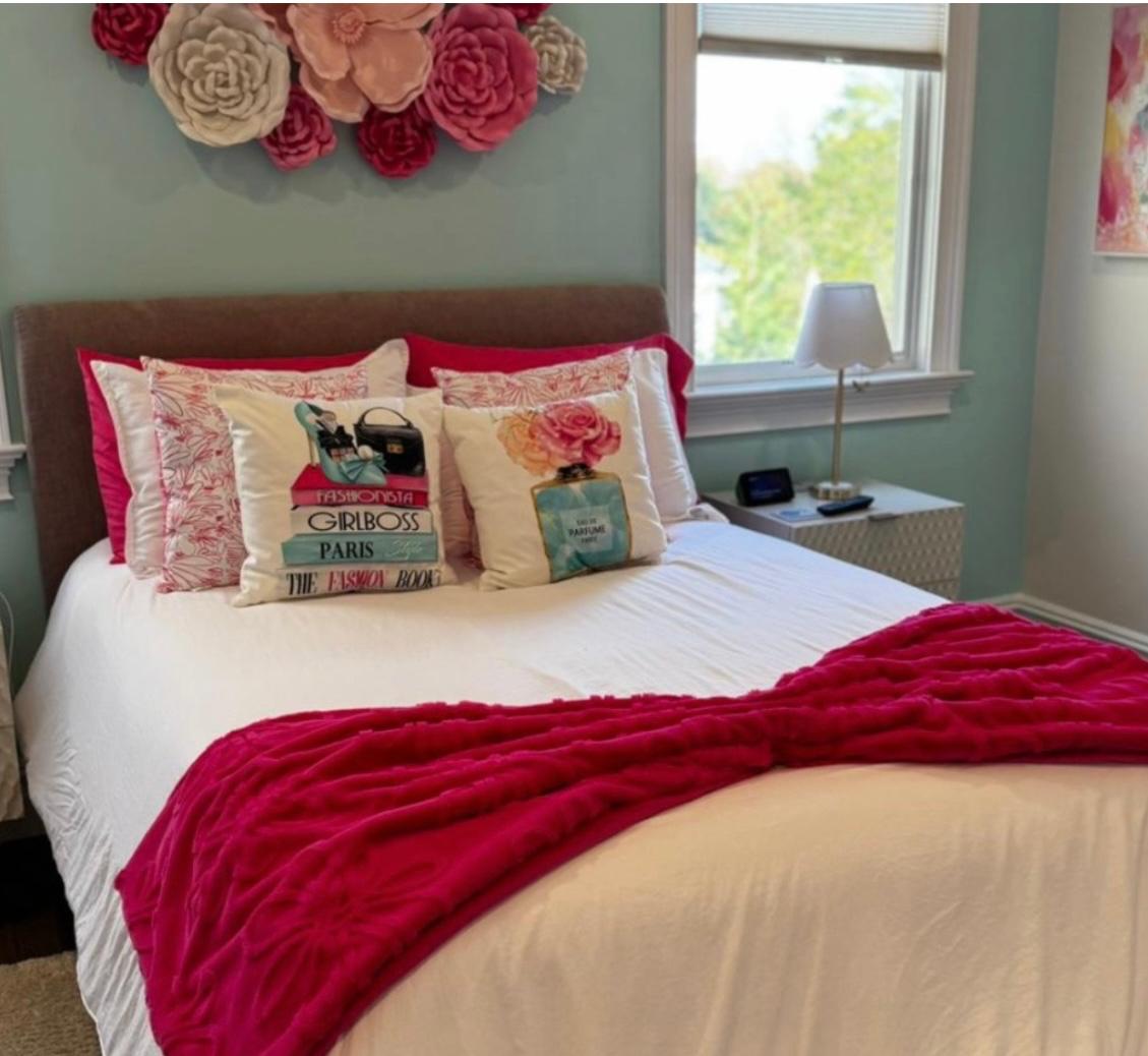 Freshly made bed and tidy bedroom after a house cleaning visit